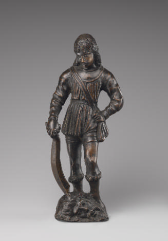 A bronze sculpture of David.  He is looking down and has a bag strapped across his body.  His l…