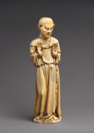 Carved ivory sculpture of St. Francis of Assisi with hands held up at his chest showing the sti…