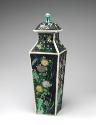 Porcelain square covered vase with black ground and floral and vegetal designs surmounted by a …