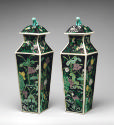 Pair of porcelain square covered vases with black ground and floral and vegetal designs