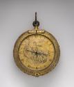 Frontal view of Gilt Brass Coach Clock-Watch showing a dial with engraved decoration of a stand…