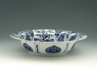 Blue and white porcelain deep plate with two figures in a landscape.