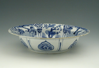 Blue and white porcelain deep plate with two figures in a landscape.