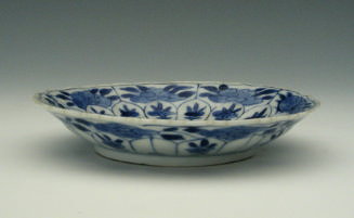 Small blue and white porcelain saucer with floral motifs.