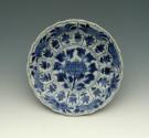 Small blue and white porcelain saucer with floral motifs, view of interior.