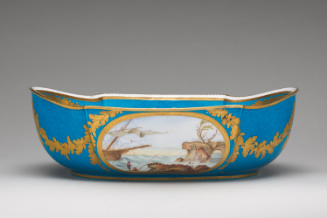 Porcelain water basin in blue, white, and gold with genre scenes
