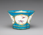 Alternate view of porcelain four-lobed dish in blue, white, and gold with birds