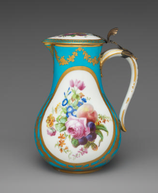 Porcelain water jug in blue, white, and gold with images of flowers