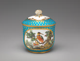 Alternate view of porcelain sugar bowl in blue and gold with an image of a bird in a tree