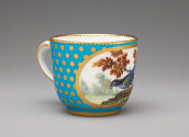 Alternate view of porcelain cup in blue and gold with bird