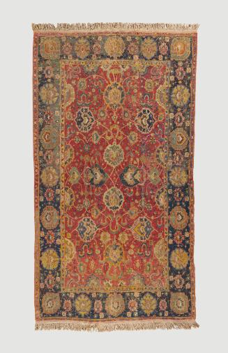 Dark red and dark blue rectangular Persian rug with floral design