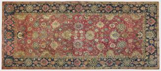 Rectangular red Persian rug with floral design and blue floral border