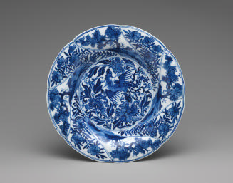 Blue and white porcelain shallow plate with bird and plant motifs