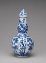 Alternate view of blue and white porcelain bottle-shaped vase with vegetal decoration