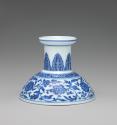 Blue and white hard-paste porcelain low candlestick with blue foliage decoration