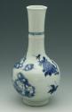 Blue and white porcelain bottle shaped vase with vegetal motifs.