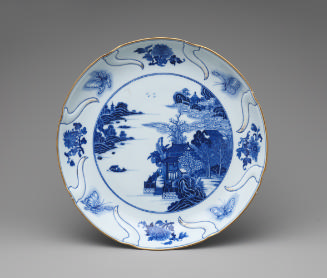 White hard-paste porcelain dish with foliate rim with underglaze blue decoration, front view