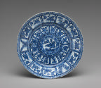 Blue and white porcelain plate with intricate design of plants and flowers