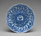 Blue and white porcelain plate with intricate design of plants and flowers