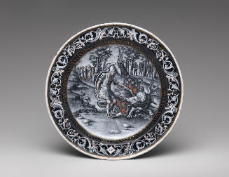 Black painted enamel dish depicting a battle scene