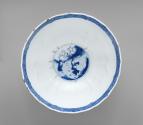 Interior view of blue and white porcelain bowl with figures in a landscape