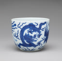 White hard-paste porcelain cup with plain rim and underglaze blue dragon decoration