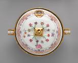 View from the top of white porcelain lidded tureen with gilded handles decorated with garlands …