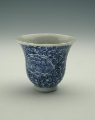 White hard-paste porcelain wine cup with underglaze blue foliage decoration