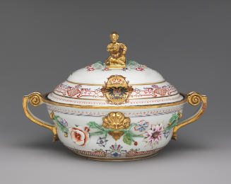 White porcelain lidded tureen with gilded handles decorated with garlands of flowers