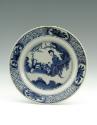White hard-paste porcelain plate with underglaze blue decoration showing figures in a landscape