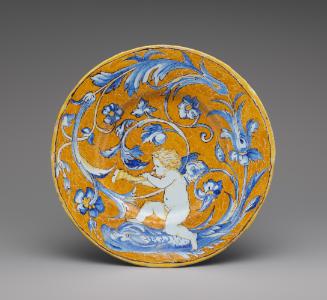 Circular plate with a putto and scrollwork against an orange background