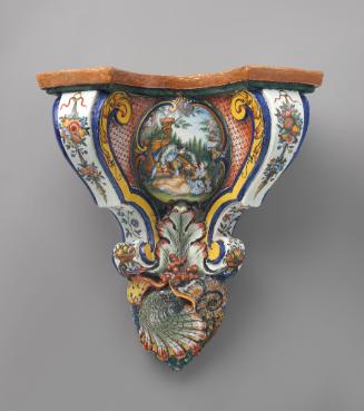 Decorative wall bracket painted in red, green and yellow with a figurative scene in the center