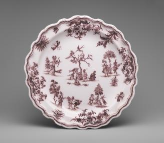 Circular plate with miniature landscapes and figures painted in dark red