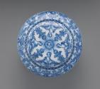 Top view of circular, covered powder box with blue scrollwork decoration