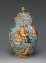 One of two covered vases with figures in a seascape, in color