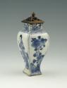 Blue and white porcelain vase with standing woman, square base, and metal lid