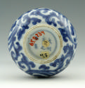 Bottom of blue and white porcelain vase with floral design and slender opening