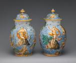 Two covered vases with figures in a seascape, in color