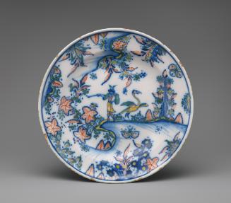 Circular plate painted with flowers, a bird and a man in color