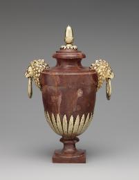 Red marble vase with gilt silver lion's head handles, gilt silver leaves around base and gilt s…