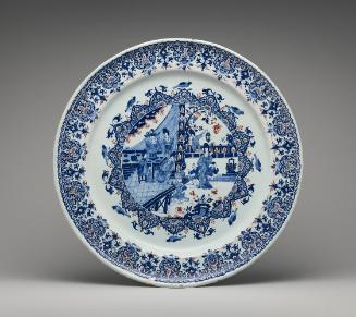 Large circular plate with oriental scene and ornate border in blue and red