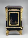 Side view of a cabinet made from Japanese black and gold laquer and ebonized wood with gilt bro…