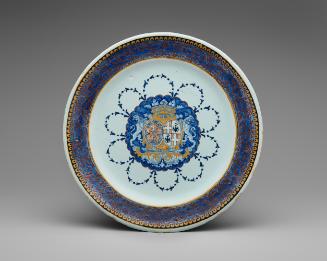 Circular plate with a coat of arms and ornate border in blue and yellow