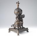Bronze sculpture of crouching Atlas supporting globe with triangular base; front view