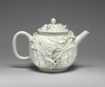 white teapot with floral relief decoration