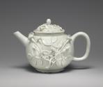 Alternate view of white teapot with floral relief decoration