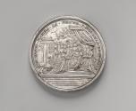 Silver medal of a queen sitting beneath a canopy in a neoclassical palatial setting with a corn…