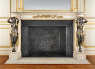 Chimneypiece with two bronze female figures on either side and gilt firedogs in the middle. A c…