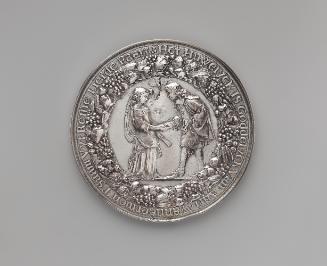 Silver medal of a man and woman holding hands, between whom a dove descends with an olive branc…