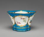 Alternate view of porcelain four-lobed dish in blue, white, and gold with birds